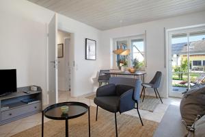 a living room with a table and a chair at Karlotta in Eriskirch