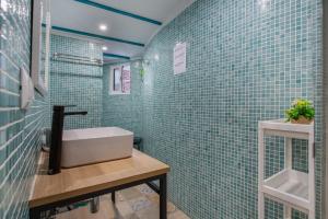 a bathroom with blue tiled walls and a sink at Finca tropical Icod in Icod de los Vinos +23 photos