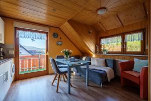 a living room with a table and a couch at Pension Haus Rose in Oberharmersbach