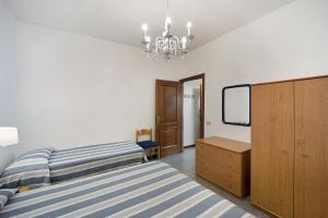 a bedroom with a bed and a dresser and a mirror at Appartamento Orizzonte 3 A in Diano Marina