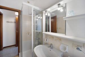 a white bathroom with a sink and a mirror at Appartamento Orizzonte 3 A in Diano Marina +18 photos