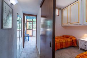 a bedroom with a bed and a door to a room at L'incanto in Palau
