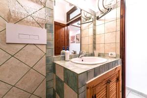 a bathroom with a sink and a mirror at L'incanto in Palau +26 photos