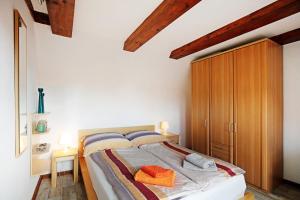 a bedroom with a bed and a wooden cabinet at Ferienhaus Engert mit Holzofensauna in Althüttendorf