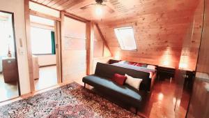 a living room with a couch and a rug at Haus am Ring in Spielberg