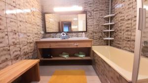 a bathroom with a sink and a tub and a mirror at Haus am Ring in Spielberg +35 photos