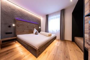 a bedroom with a large bed in a room at Sonnleiten Sonnenadler 4 in Collepietra +25 photos