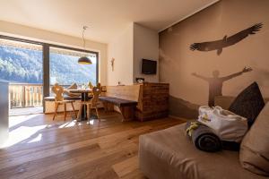 a living room with a bird mural on the wall at Sonnleiten Sonnenadler 4 in Collepietra