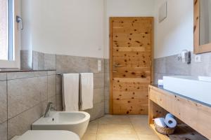 a bathroom with a toilet and a sink at Apartments Marialisa Superior Orchi in Chiusa +34 photos