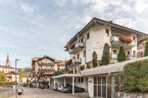a white building with balconies on a city street at Apartments Marialisa Superior Orchi in Chiusa