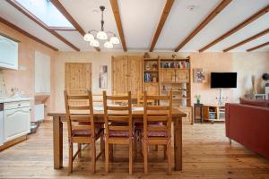 a dining room with a table and wooden chairs at Ferienhaus Sundperle in Stralsund +27 photos