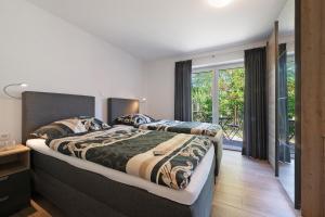 a bedroom with two beds and a balcony at Gästehaus Anna in Suhle