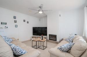 a living room with two couches and a fireplace at Ca na Barons in Bunyola