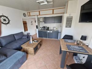 a living room with a couch and a table at Haus Meereswelle in Büsum