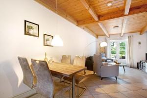a dining room with a wooden table and chairs at Green Oasis Ferienwohnung in Treia