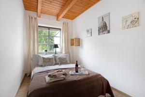a bedroom with a bed with a bottle of wine on it at Green Oasis Ferienwohnung in Treia