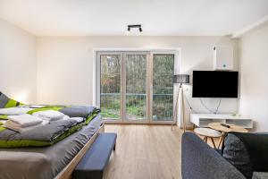 a living room with a couch and a tv at Grötacker Wohnung 6 in Husby