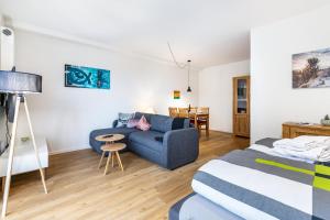 a room with a bed and a couch and a table at Grötacker Wohnung 6 in Husby