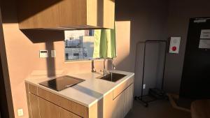 a kitchen with two sinks and a window at WINN hotel in Tokyo +10 photos