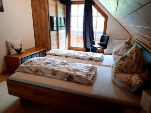 two beds in a room with a window at Ferienwohnung Schwarzwaldfeder in Todtnau