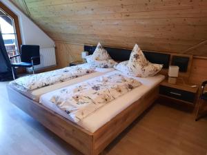 a bedroom with a large bed in a wooden room at Ferienwohnung Schwarzwaldfeder in Todtnau