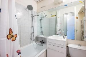 a bathroom with a butterfly shower curtain and a sink at Studio Avec Vue Splendide in Villarembert