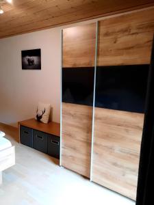 a bedroom with a large wooden sliding door at Ferienwohnung Schwarzwaldfeder in Todtnau