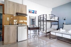 a kitchen and a living room with bunk beds at Iguana studio 11 in Preveza