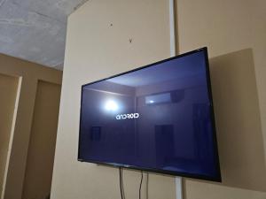 a flat screen tv hanging on a wall at Smithy's Apartment 1 in Brighton Village