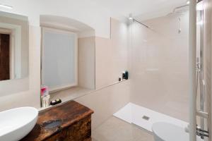 a white bathroom with a shower and a sink at Casa Patty Moena in Moena +21 photos