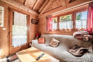 a room with a bed in a wooden cabin at Chalet 7p Confort - Le refuge in Verchaix