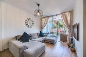 a living room with a couch and a tv at Marbella Beach San Pedro in Marbella +19 photos