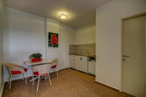 a kitchen with a table and chairs in a room at Moon Cnter in Majdal Shams