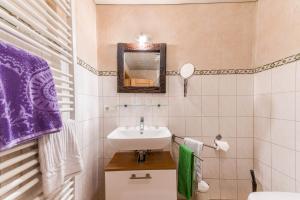 a small bathroom with a sink and a mirror at Ferienwohnung Daniel in Grainau +14 photos