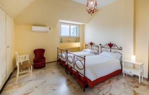a bedroom with two beds and a chandelier at La dimora di Alda in Lavagna