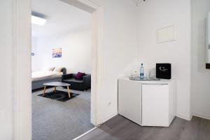 a white living room with a couch and a table at Wendelin in Sankt Wendel