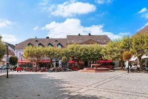 a town square with tables and chairs and buildings at Wendelin in Sankt Wendel