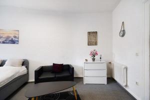 a bedroom with a bed and a chair and a table at Wendelin in Sankt Wendel