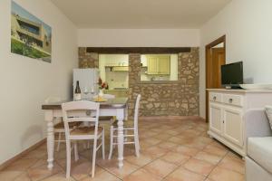 a kitchen and dining room with a table and chairs at Podere Nuti - 4 Lauro in Cecina