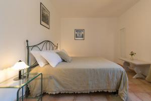 a bedroom with a bed with a lamp and a desk at Podere Nuti - 4 Lauro in Cecina +21 photos
