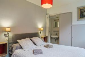 a bedroom with a bed with two books on it at Ti Bihan - Perros Guirec in Perros-Guirec