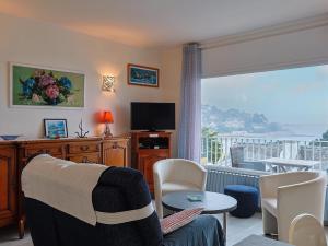 a living room with a couch and a large window at Ti Bihan - Perros Guirec in Perros-Guirec