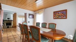 a dining room with a wooden table and chairs at Ferienhaus Mengelberg in Roschbach +27 photos