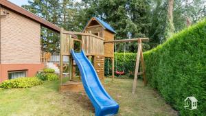 a playground with a slide and a play house at Ferienhaus Mengelberg in Roschbach