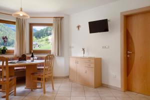 a kitchen and dining room with a table and a window at Ferienhaus Berger in Sarntal