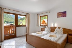 a bedroom with a bed and a large window at Ferienhaus Berger in Sarntal +65 photos