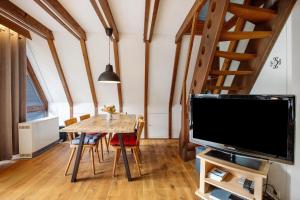 a dining room with a table and a tv at Ferienhaus Amrhein in Siegsdorf