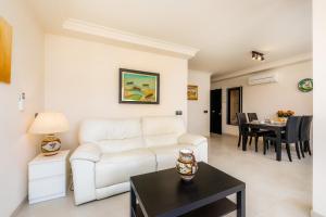 a living room with a white couch and a table at Gala in Cala Ratjada