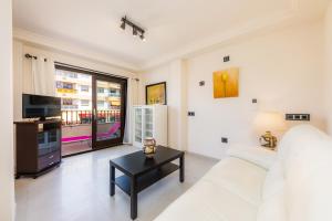 a living room with a white couch and a table at Gala in Cala Ratjada