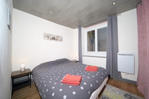 a bedroom with a bed with two red towels on it at Le Gite des 3000 avec Spa in Auzat